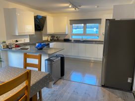 A kitchen with a fridge and sink at Pityme-Not Wadebridge