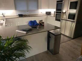 A kitchen with a countertop, sink, and appliances at Pityme-Not in Wadebridge