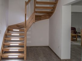 A staircase with wooden steps and a handrail at Pityme-Not Wadebridge