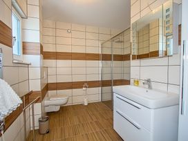 A bathroom with a sink, toilet, and shower at Pityme-Not in Wadebridge