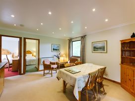 A dining room with table and chairs at Buzzard Lodge in Crianlarich