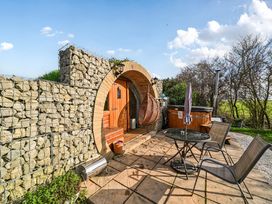 An outdoor area with a hot tub and seating at Cosy Escape Minster On Sea