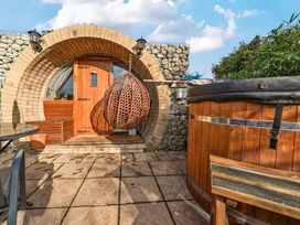 An outdoor area with a door and a hot tub at Cosy Escape in Minster On Sea