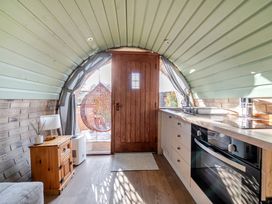 A kitchen with a counter and hanging chair at Cosy Escape in Minster On Sea
