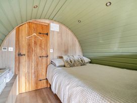 A bedroom with a bed and wooden door at Cosy Escape in Minster On Sea
