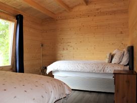 A bedroom with two beds and a window at Cotswold Nights Away Evesham