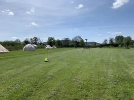 An outdoor area with tents and play equipment at Cotswold Nights Away Evesham