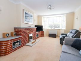 A living room with a fireplace and sofa at 15 Coombe Avenue