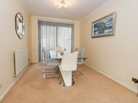 A dining room with a table and chairs at 15 Coombe Avenue 