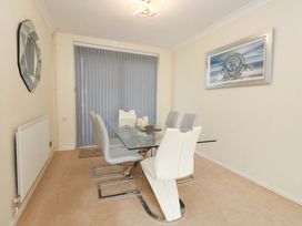A dining room with a table and chairs at 15 Coombe Avenue
