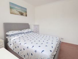 A bedroom with a bed and chest of drawers at 15 Coombe Avenue