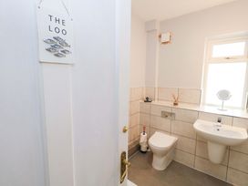 A bathroom with a toilet and sink at 15 Coombe Avenue