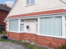 A brick exterior with windows and plants at 15 Coombe Avenue