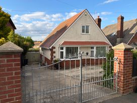 A house with a gate and driveway at Tudor Rose in Weymouth