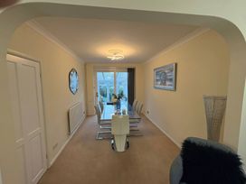 A dining room with a table and chairs at Tudor Rose in Weymouth