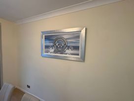 A framed artwork on a wall at Tudor Rose Weymouth