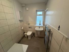 A bathroom with a sink and toilet at Tudor Rose in Weymouth
