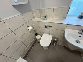 A bathroom with a toilet and sink at Tudor Rose in Weymouth