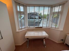 An office with a desk and blinds at Tudor Rose in Weymouth