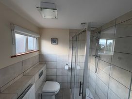 A bathroom with a shower and toilet at Tudor Rose in Weymouth