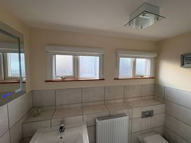 A bathroom with a sink and toilet at Tudor Rose in Weymouth