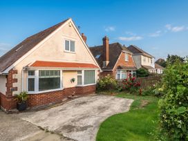 A house with a driveway and garden at Tudor Rose in Weymouth