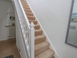 A staircase in a hallway at Tudor Rose in Weymouth
