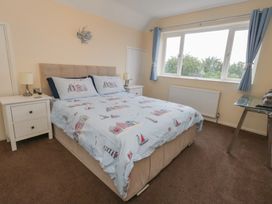A bedroom with a bed and bedside tables at Tudor Rose in Weymouth