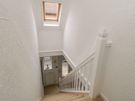 A staircase leading to a door at Tudor Rose in Weymouth