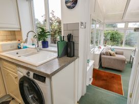 A kitchen with a sink and washing machine at Tudor Rose in Weymouth