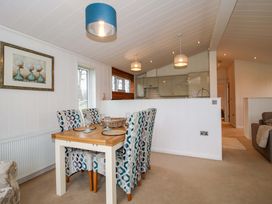 A dining area with a table and chairs at 5 Hillview Lodges Cleobury Mortimer