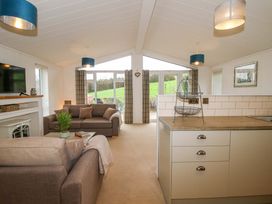 A living room with a sofa and television at 5 Hillview Lodges in Cleobury Mortimer