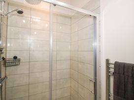 A shower area with tiles and a towel rail at 5 Hillview Lodges Cleobury Mortimer