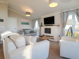 A living room with a sofa and television at Moorland View