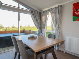 A dining room with a table and chairs at Moorland View