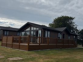 A house with a deck and multiple windows at Moorland View in Dobwalls