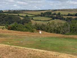 A golf course with a flag and grass at Moorland View in Dobwalls