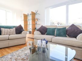 A living room with sofas and a glass table at Wansfell View Ambleside