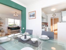 A dining room with a table set for a meal at Wansfell View in Ambleside