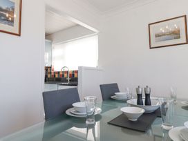 A dining room with a table set for meals at Wansfell View in Ambleside