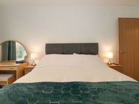 A bedroom with a bed and table at Wansfell View in Ambleside