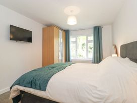 A bedroom with a bed and wardrobe at Wansfell View in Ambleside