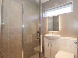 A bathroom with a shower, sink, and toilet at Wansfell View in Ambleside