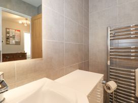 A bathroom with a sink and towel rack at Wansfell View in Ambleside