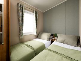 A bedroom with two beds and a window at Ashberry 39 x 12 Three Bed- 2 Northwich