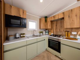 A kitchen with cabinets and appliances at Ashberry 39 x 12 Three Bed- 3 Northwich