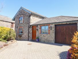A house with a garage and driveway at Pillars in Barnstaple