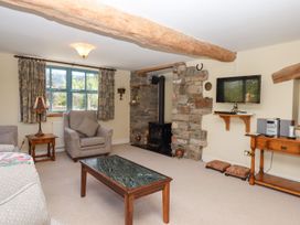 A living room with a fireplace and television at Pillars Barnstaple