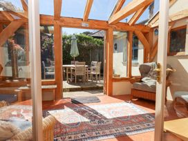 A conservatory with a table and chairs at Pillars in Barnstaple