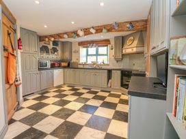 A kitchen with cabinets and appliances at Pillars in Barnstaple